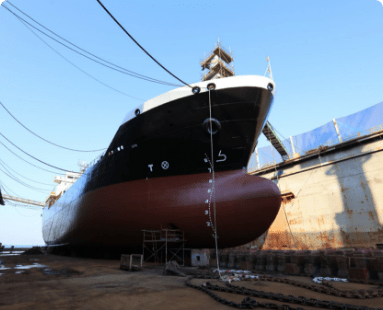 image showing a ship docked at the port and Dry Docking services by white pigeon marine services being performed on it